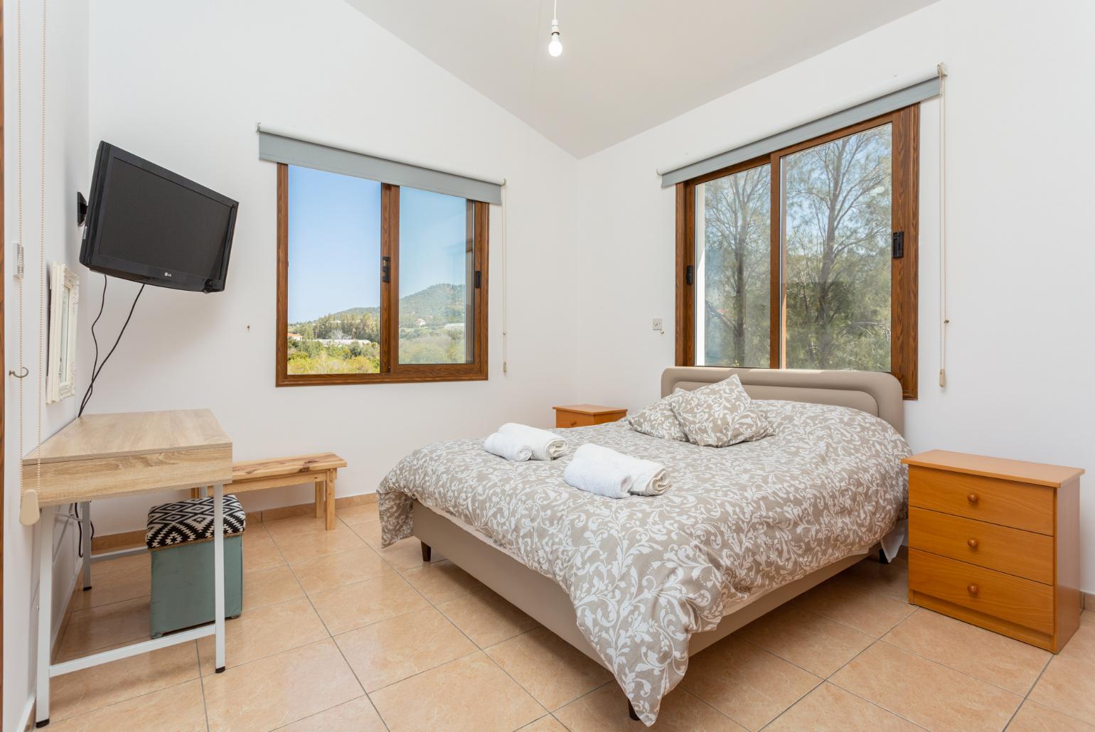 Double bedroom with en suite bathroom, A/C, TV, and upper terrace access with sea views