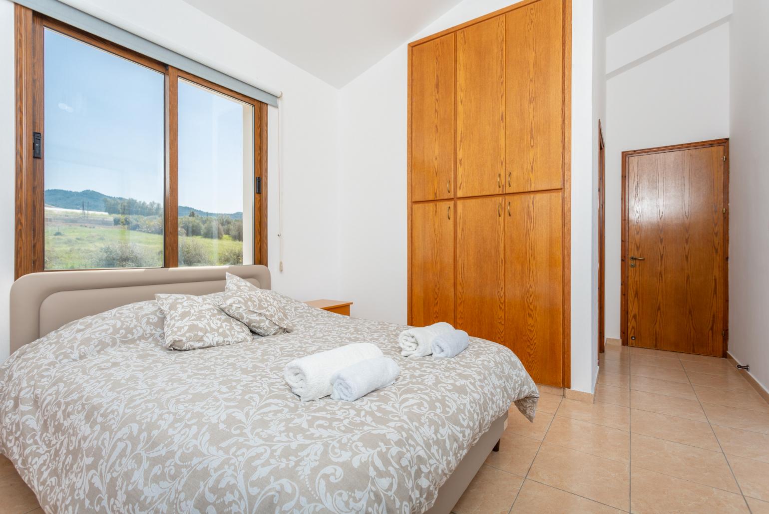 Double bedroom with en suite bathroom, A/C, TV, and upper terrace access with sea views