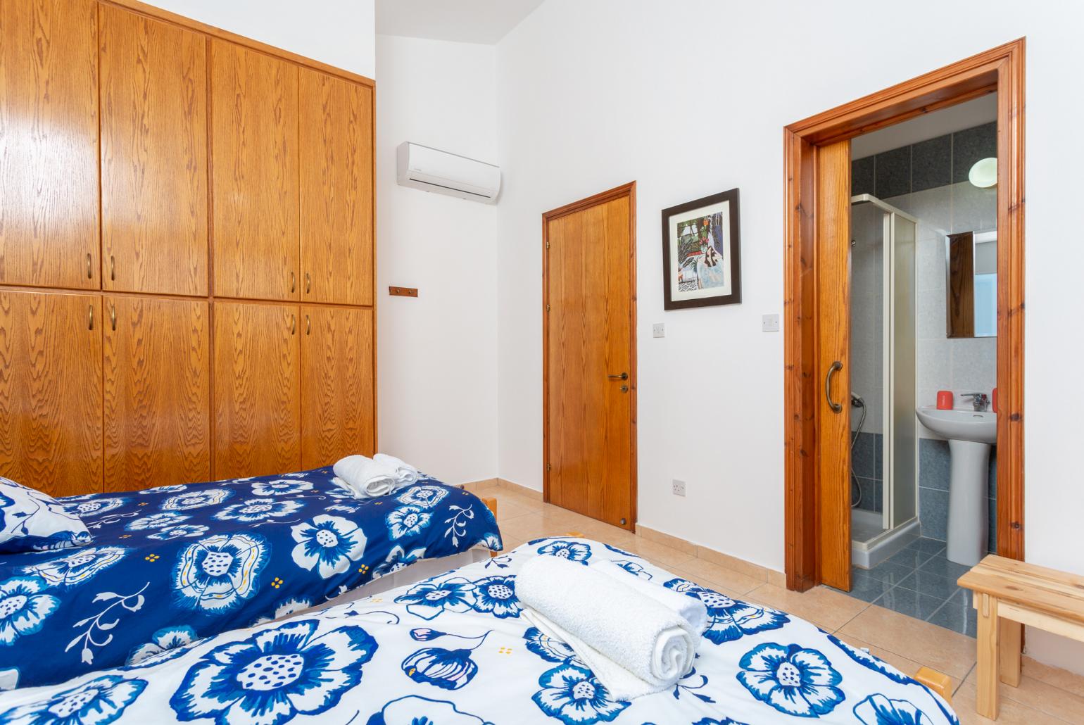 Twin bedroom with en suite bathroom, A/C, and balcony access with sea views