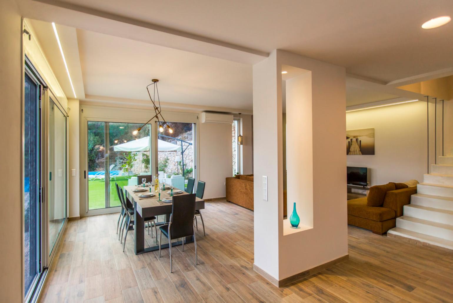 Open plan living room with A/C, TV and ornamental fireplace