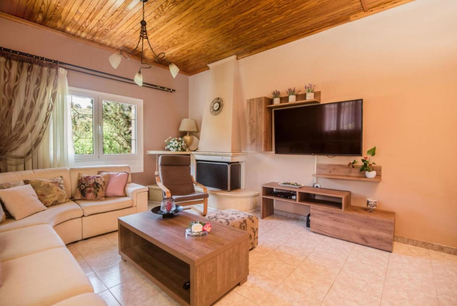 Living room  with A/C, TV and ornamental fireplace