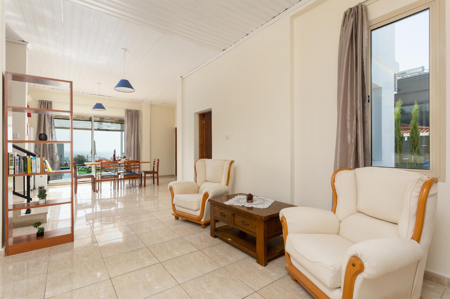 Open-plan living room on ground floor with sofa and seats, dining area, kitchen, WiFi internet, satellite TV, and sea views