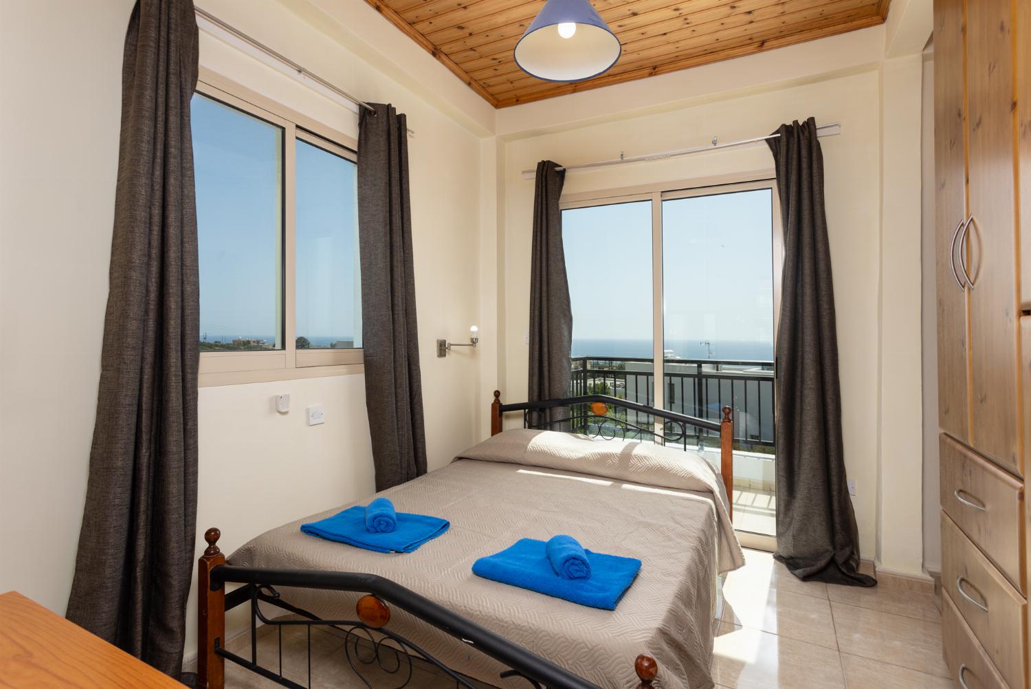 Double bedroom on first floor with en suite bathroom, A/C, sea views, and balcony access