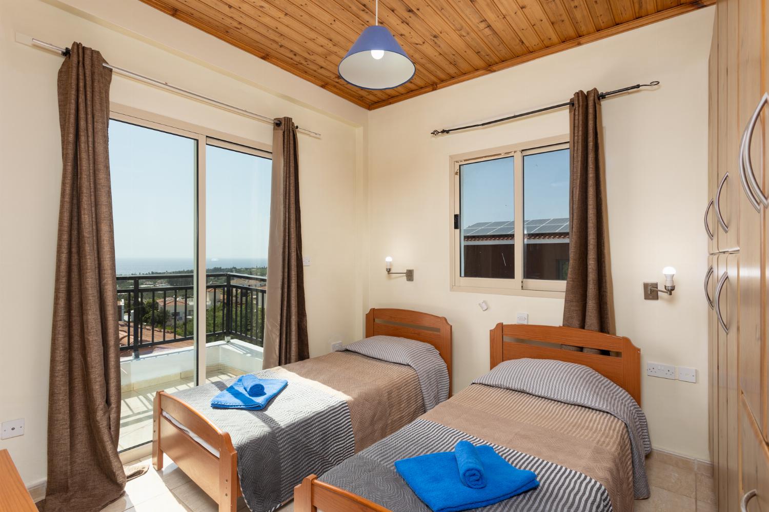 Twin bedroom on first floor with en suite bathroom, A/C, sea views, and balcony access