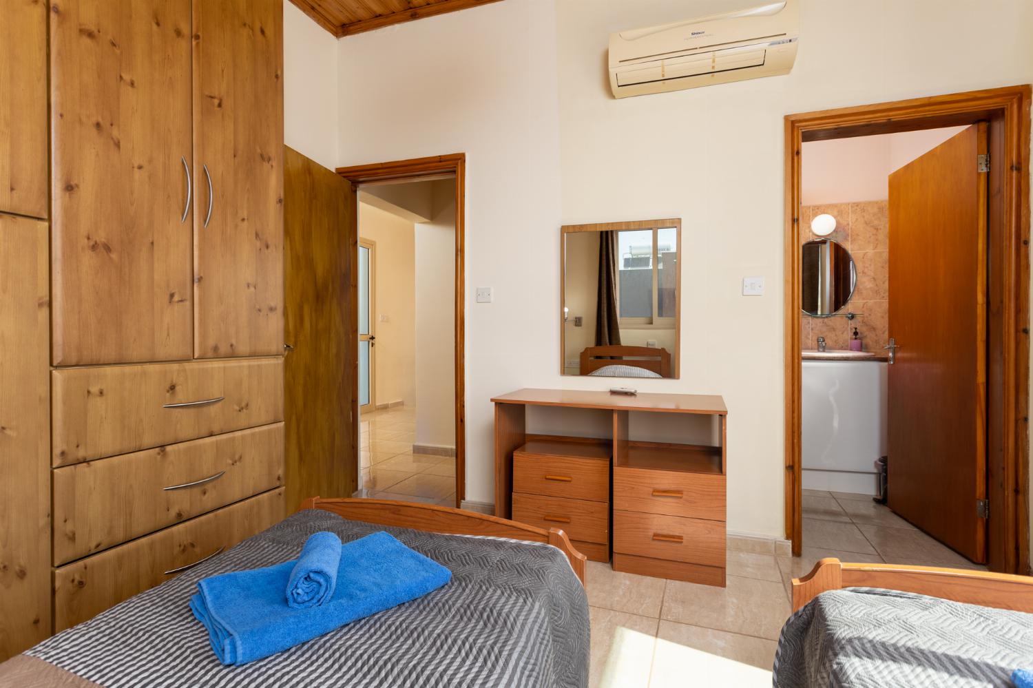 Twin bedroom on first floor with en suite bathroom, A/C, sea views, and balcony access