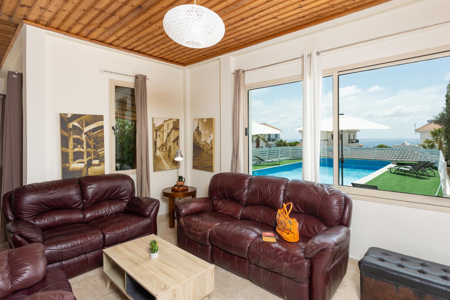 Open-plan living room with sofas, dining area, kitchen, WiFi internet, satellite TV, and sea views