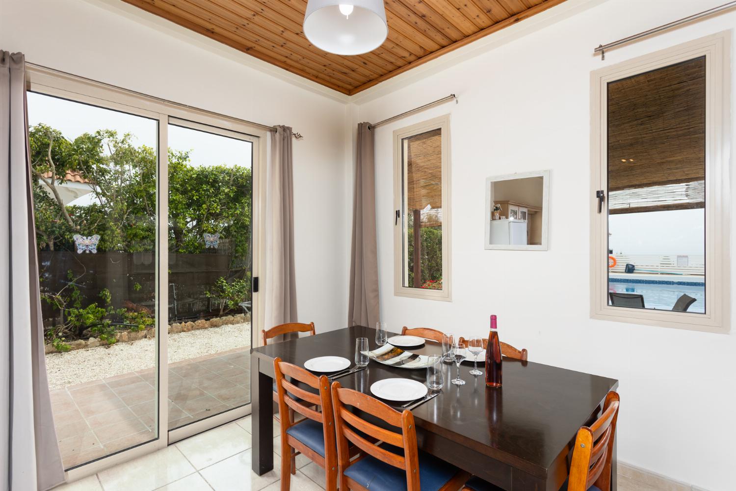 Open-plan living room with sofas, dining area, kitchen, ornamental fireplace, WiFi internet, satellite TV, and sea views