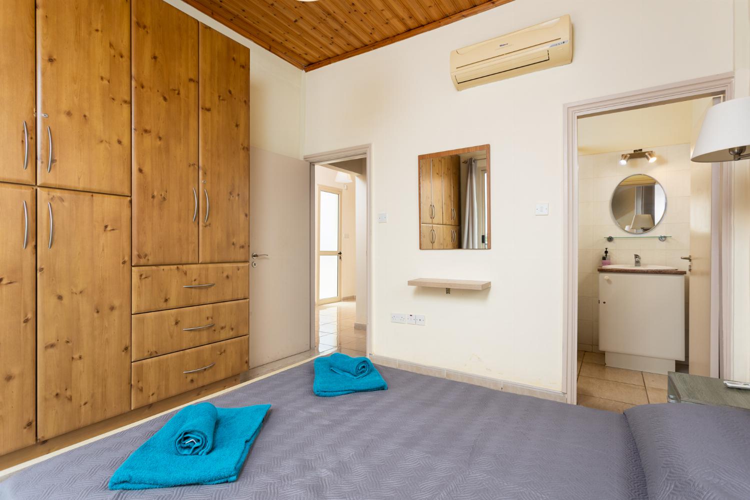 Double bedroom with en suite bathroom, A/C, and balcony access