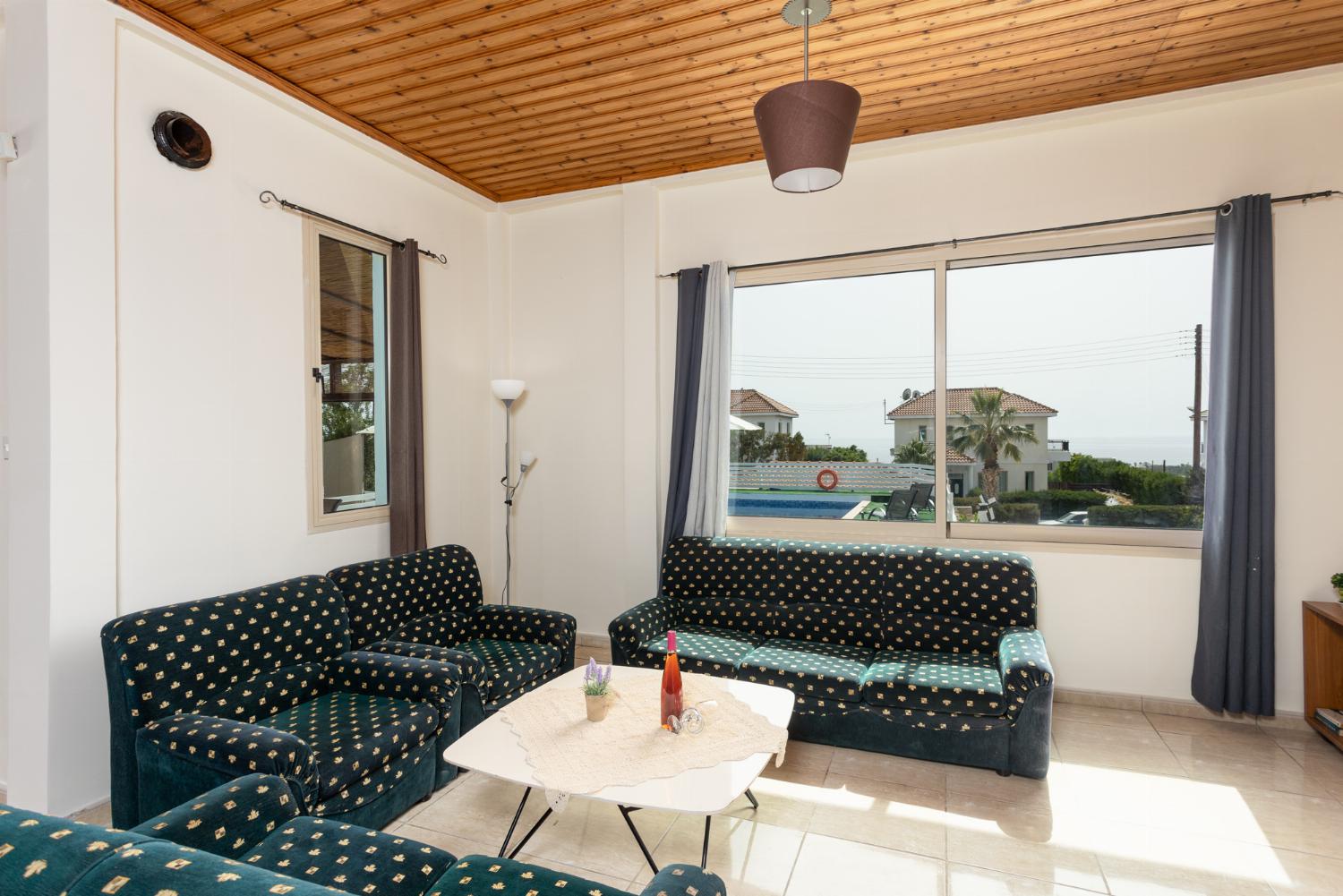 Open-plan living room with sofas, dining area, kitchen, WiFi internet, satellite TV, and sea views