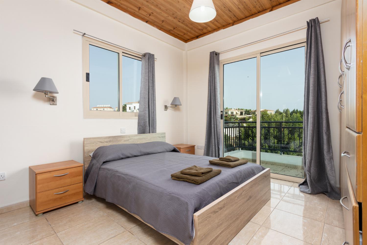 Double bedroom with en suite bathroom, A/C, and balcony access