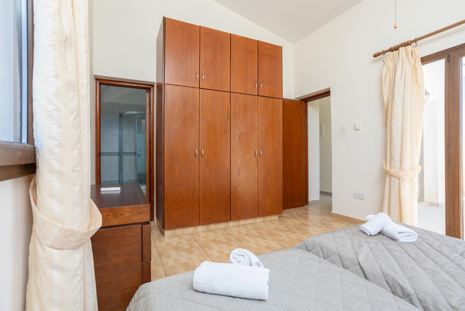 Twin bedroom with en suite bathroom, A/C, and upper terrace access