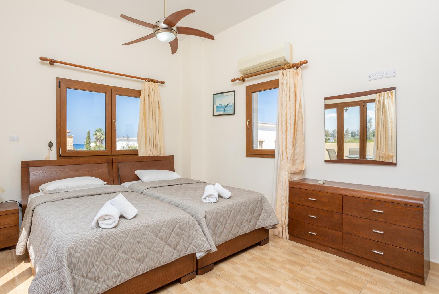 Twin bedroom with en suite bathroom, A/C, and upper terrace access