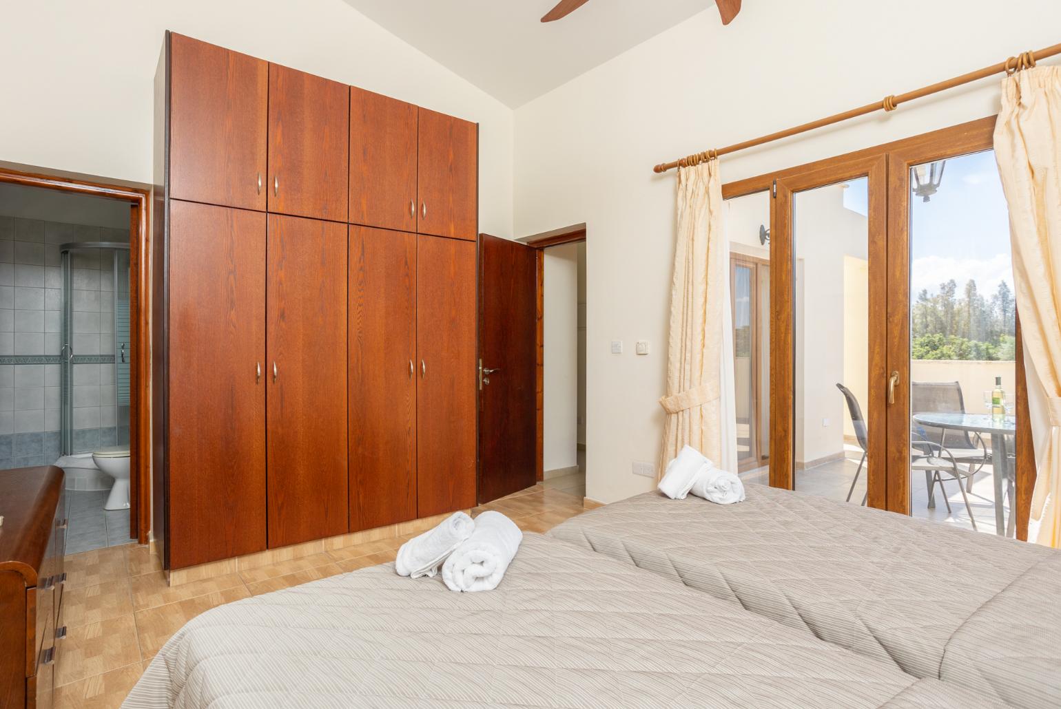 Twin bedroom with en suite bathroom, A/C, and upper terrace access