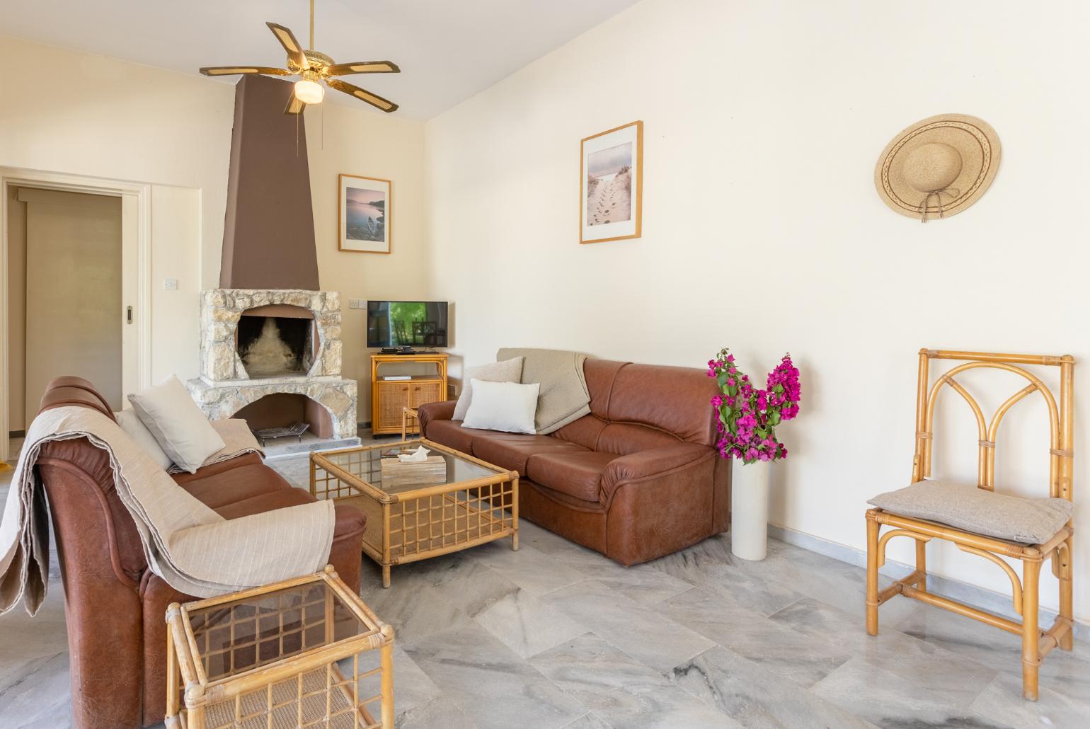 Living room with sofas, dining area, ornamental fireplace, A/C, WiFi internet, and satellite TV