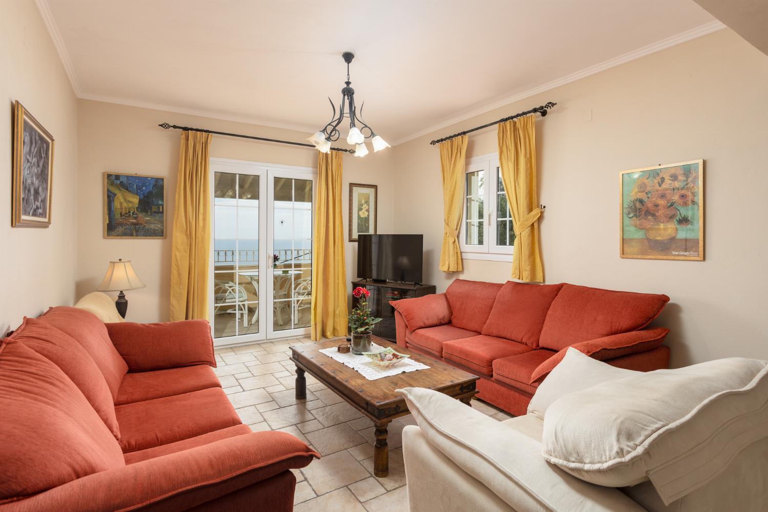 Living room on first floor with sofas, WiFi internet, satellite TV, and balcony access