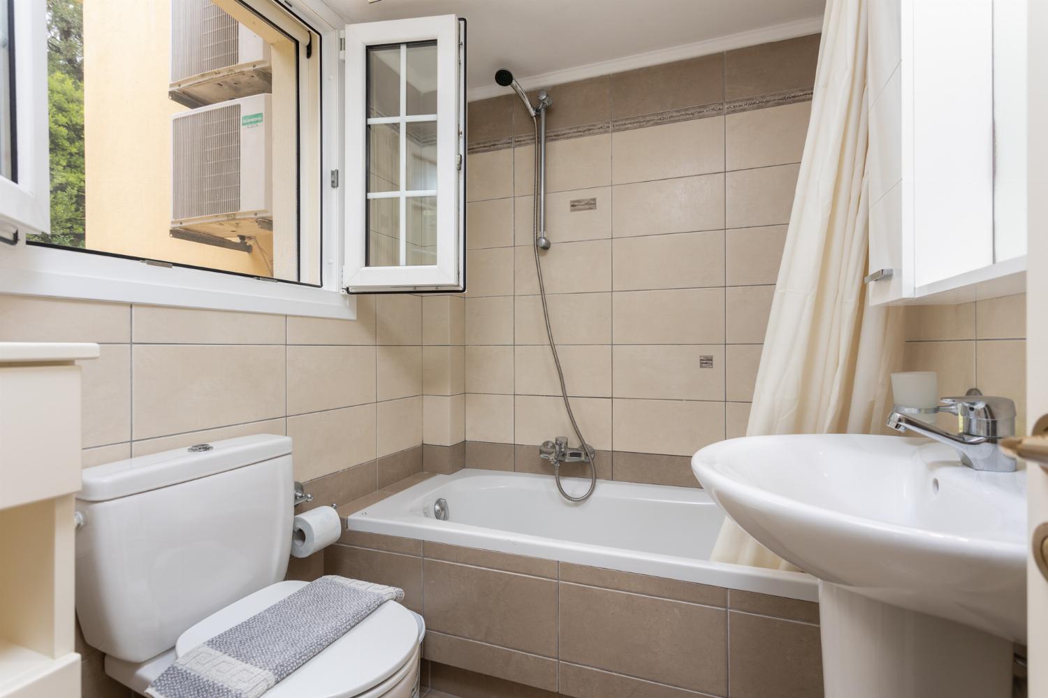 Family bathroom with bath and shower