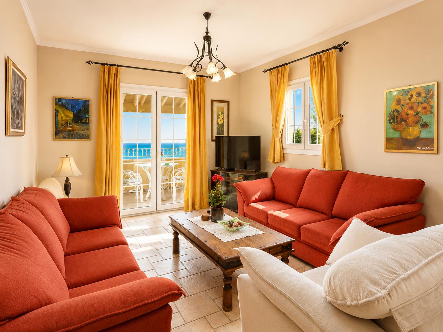 Living room on first floor with sofas, WiFi internet, satellite TV, and balcony access