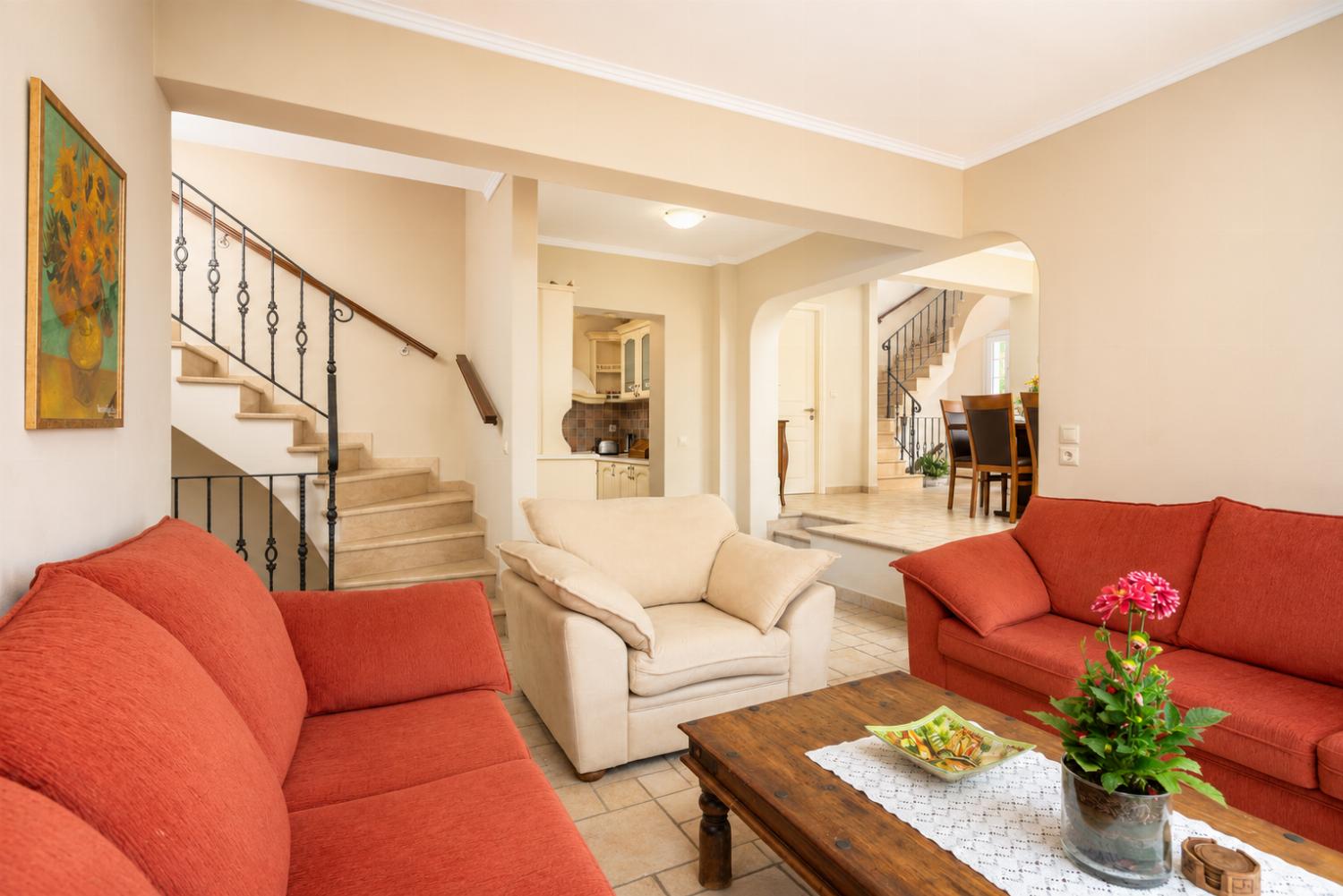 Living room on first floor with sofas, WiFi internet, satellite TV, and balcony access