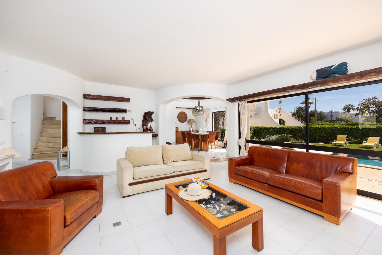 Living room with sofas, dining area, ornamental fireplace, A/C, WiFi internet, and satellite TV