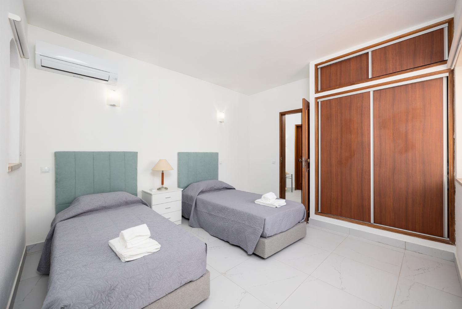 Twin bedroom with en suite bathroom and A/C