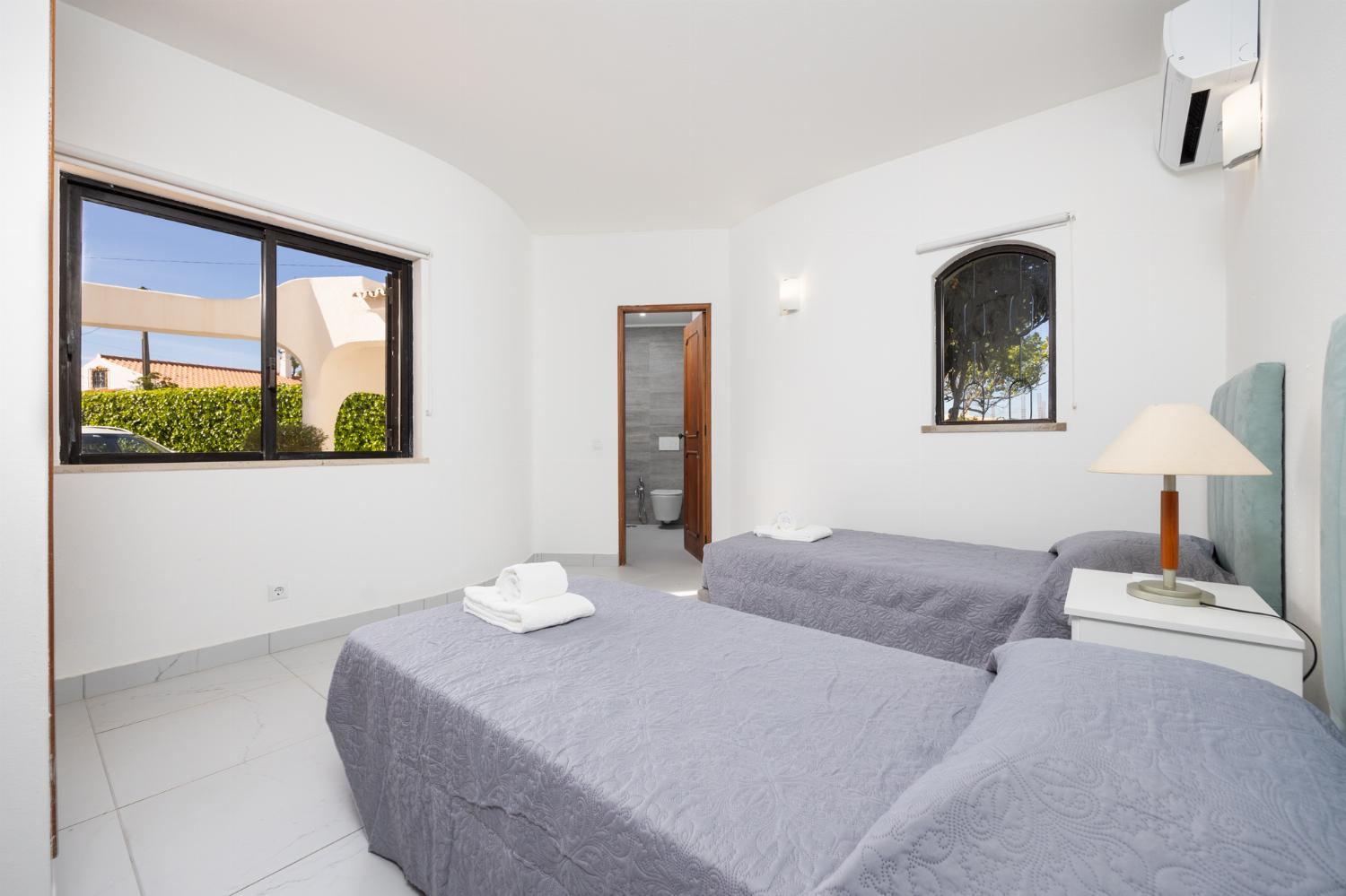Twin bedroom with en suite bathroom and A/C