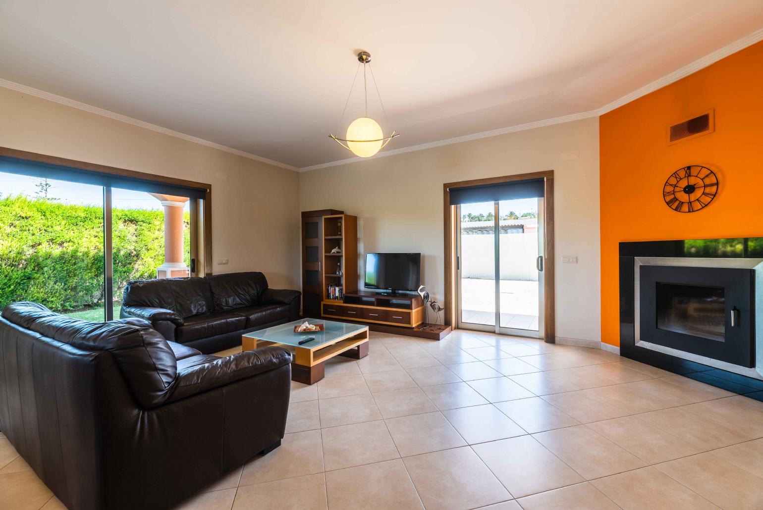 Living room with comfortable sofa and ornamental fire place