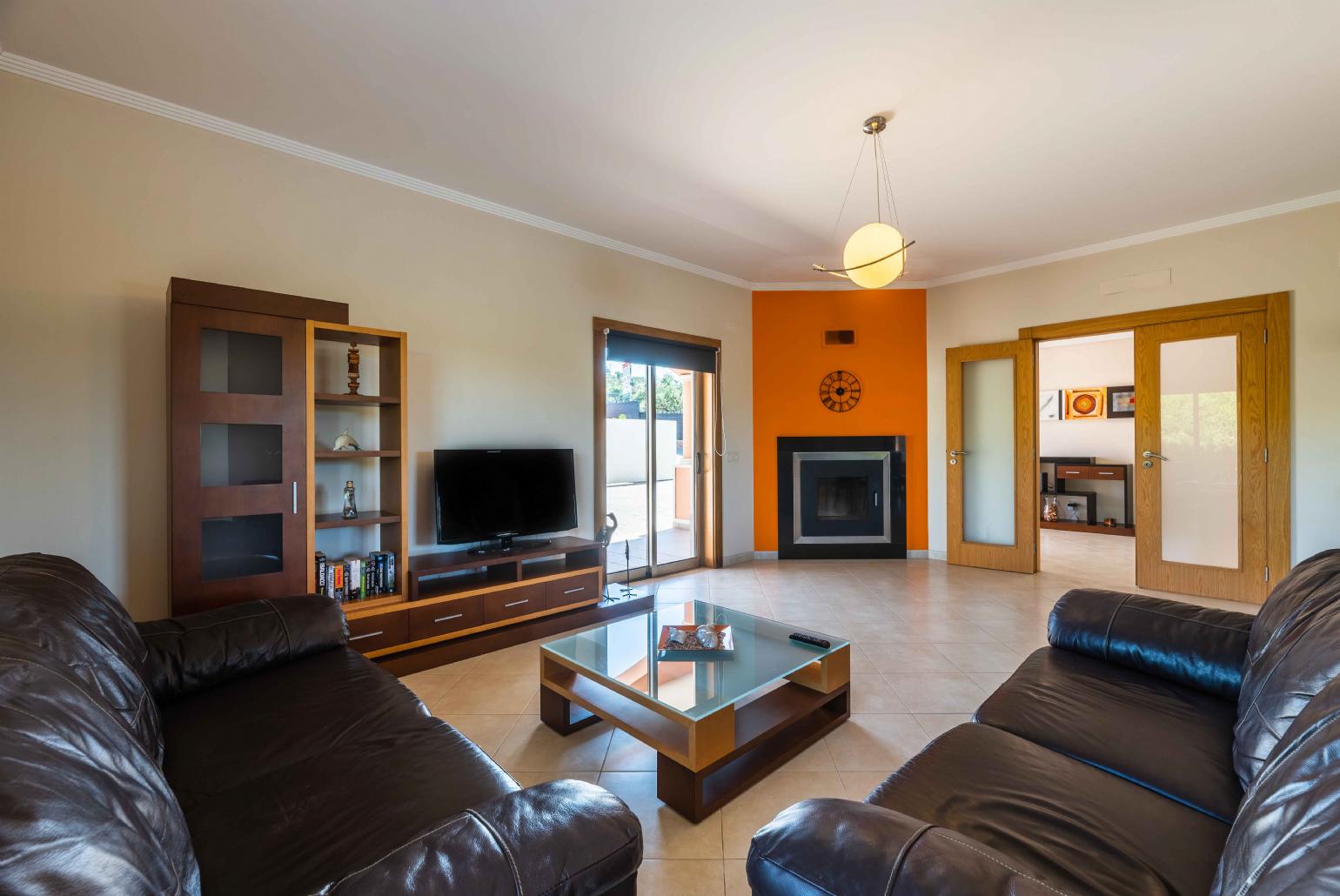 Living room with comfortable sofa and ornamental fire place