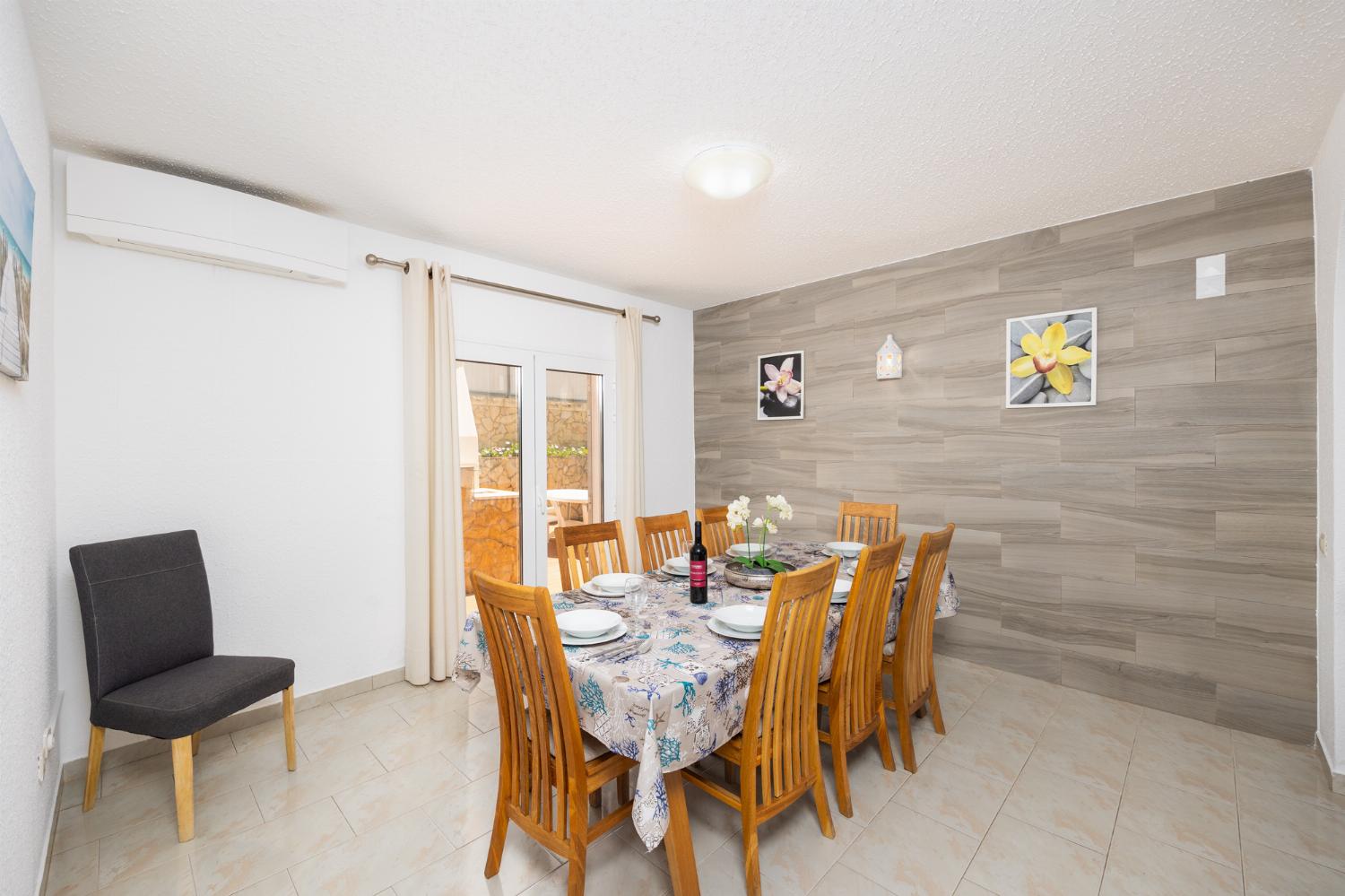 Living room with sofas, dining area, ornamental fireplace, A/C, WiFi internet, and satellite TV