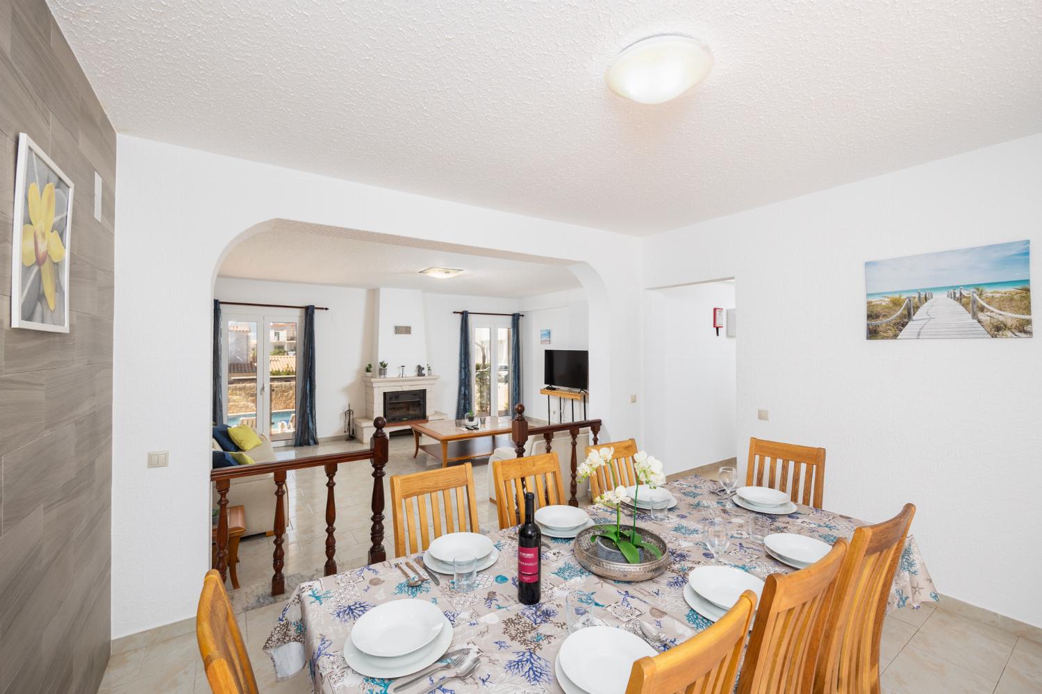 Living room with sofas, dining area, ornamental fireplace, A/C, WiFi internet, and satellite TV