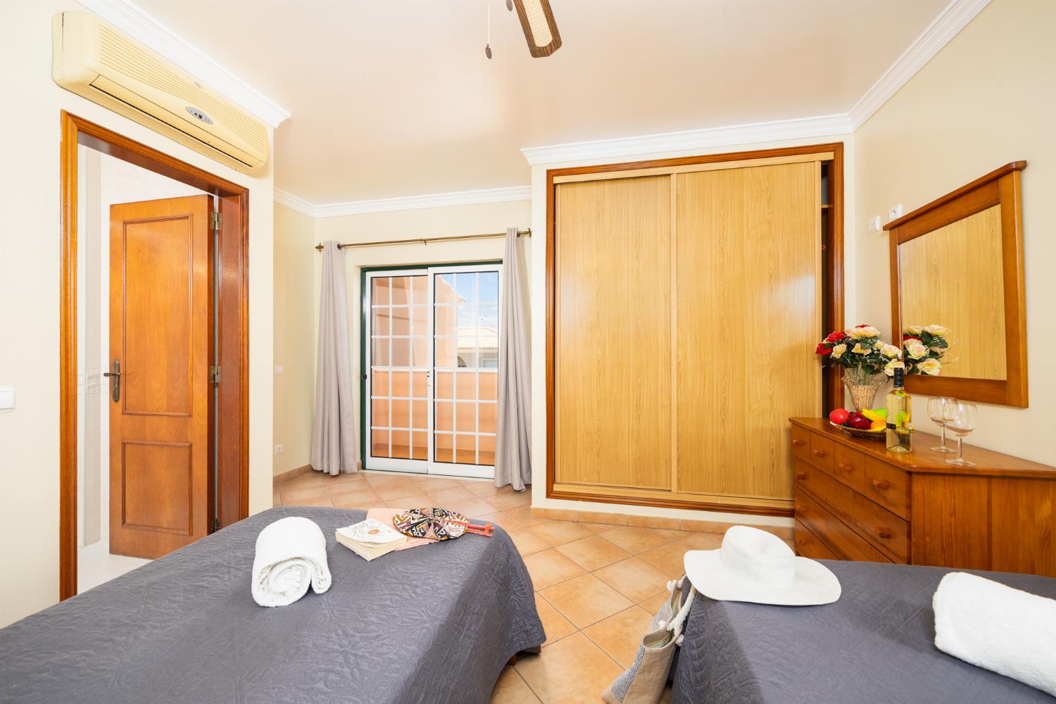 Twin bedroom with en suite bathroom and A/C