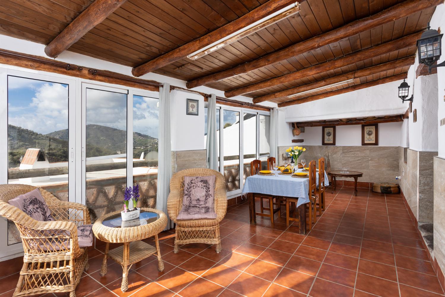 Sun room with dining area, seating, and mountain views