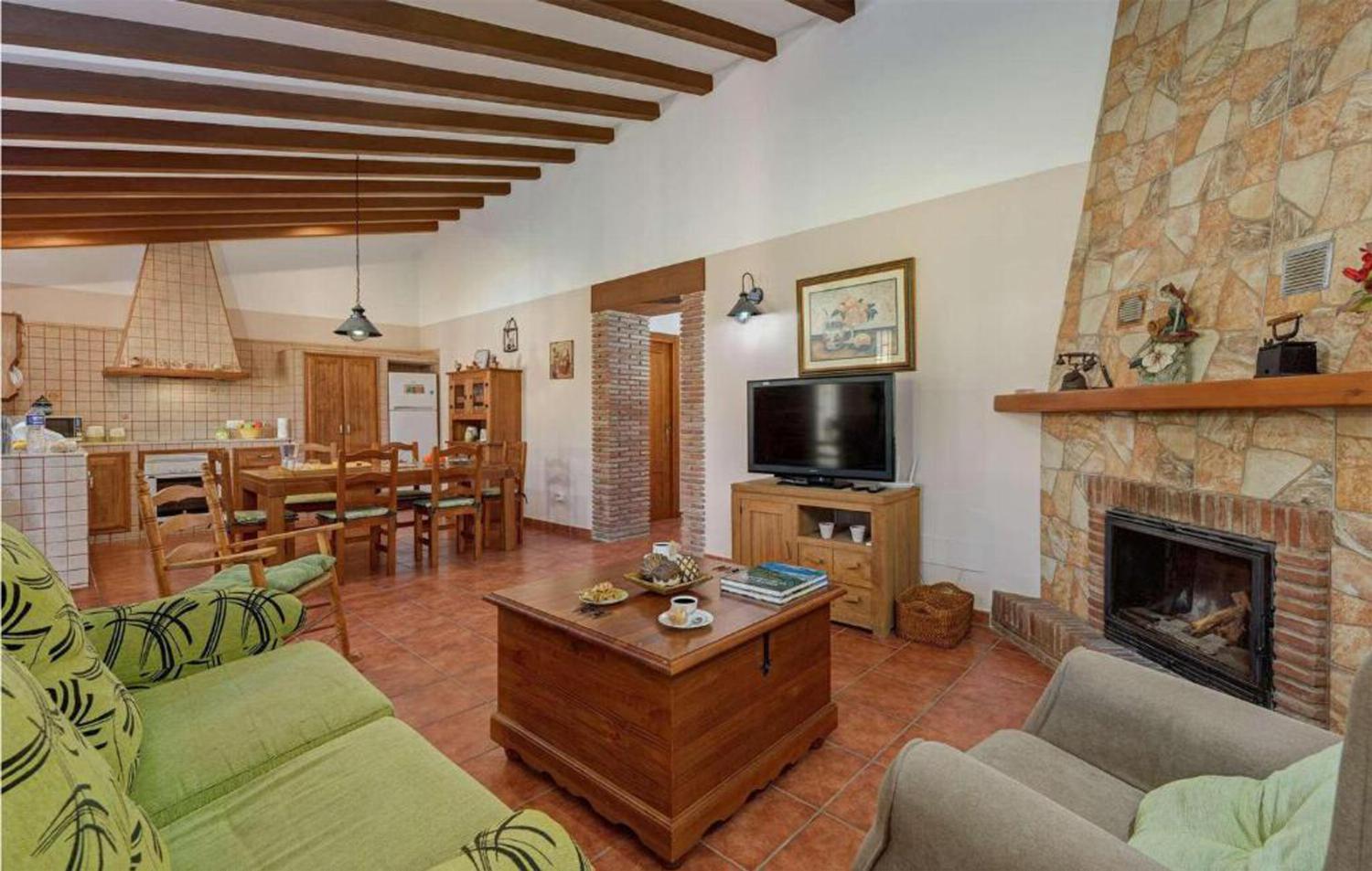 Open-plan living room with sofas, dining area, kitchen, A/C, WiFi internet, satellite TV, patio doors