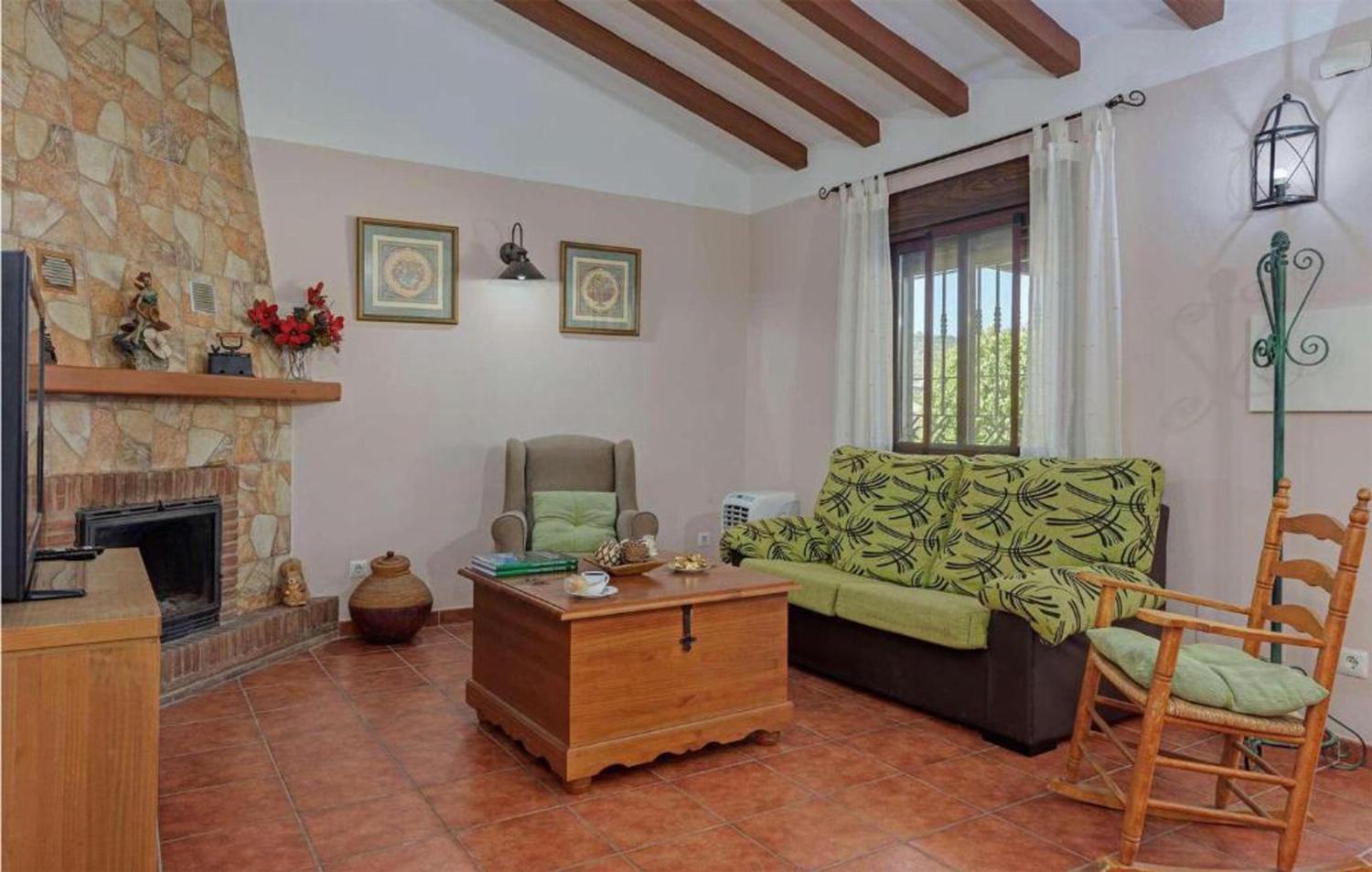 Open-plan living room with sofas, dining area, kitchen, A/C, WiFi internet, satellite TV, patio doors