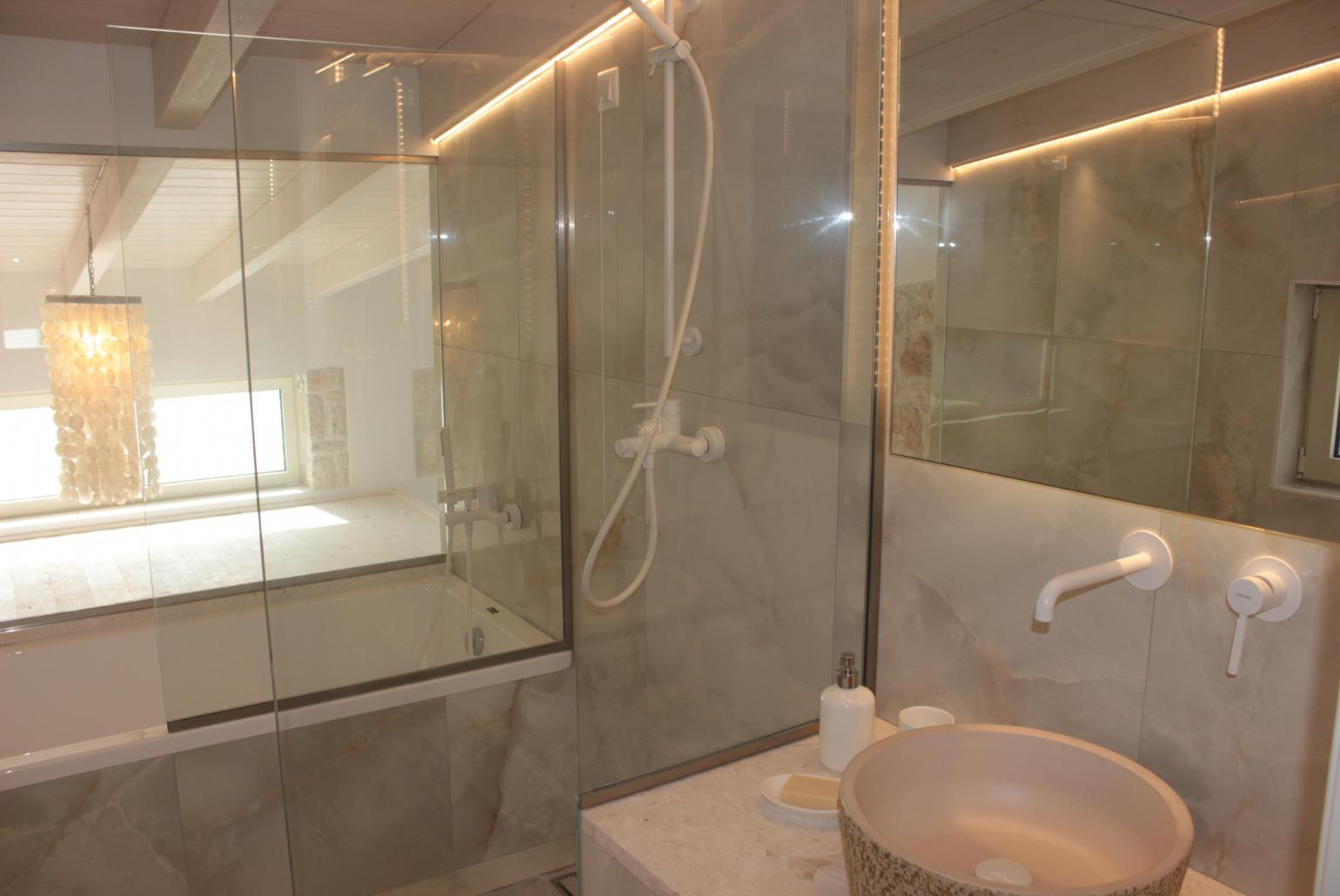 En suite bathroom with bath and shower