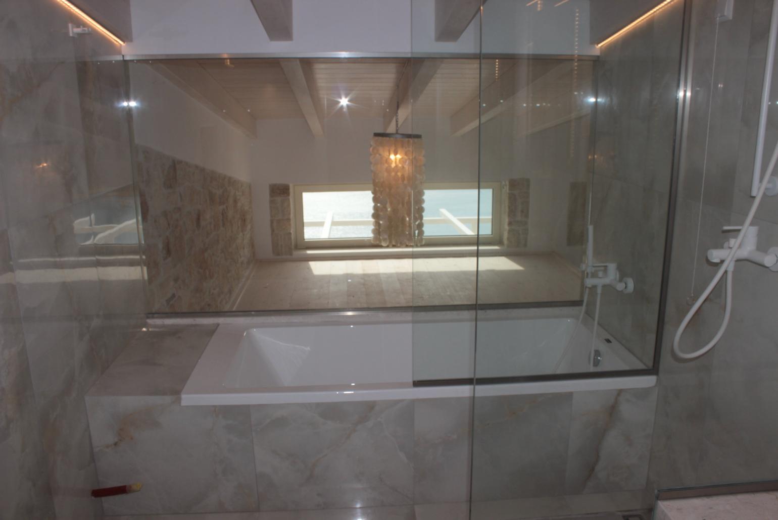 En suite bathroom with bath and shower