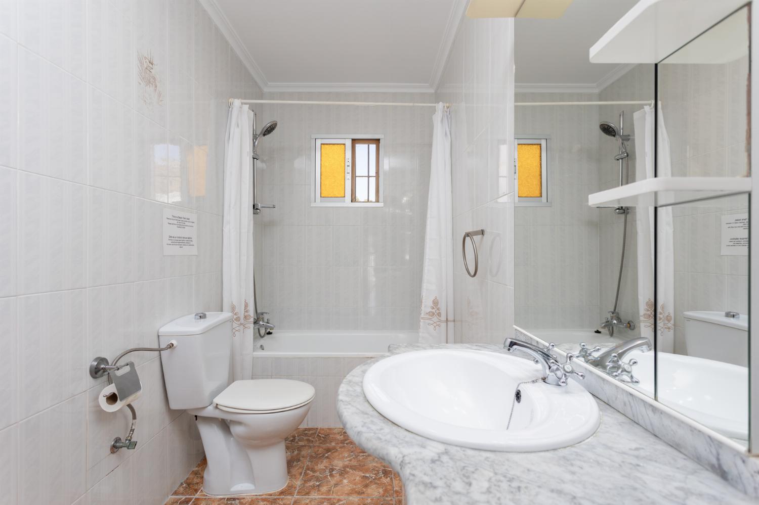 Family bathroom with bath and shower