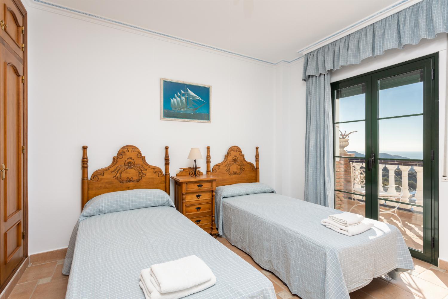 Twin bedroom with en suite bathroom, A/C, sea views, and balcony access