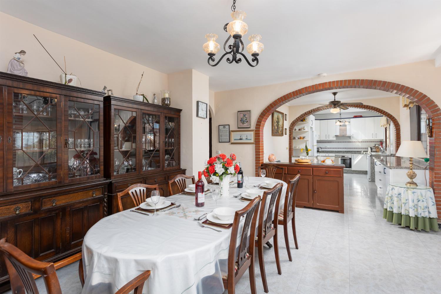 Open-plan living room with sofas, dining area, kitchen, ornamental fireplace, A/C, WiFi internet, satellite TV, and sea views