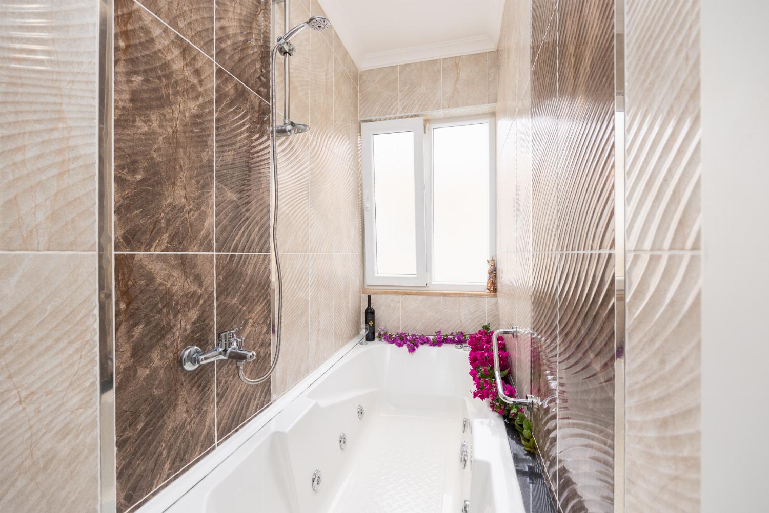 En suite bathroom with bath and shower