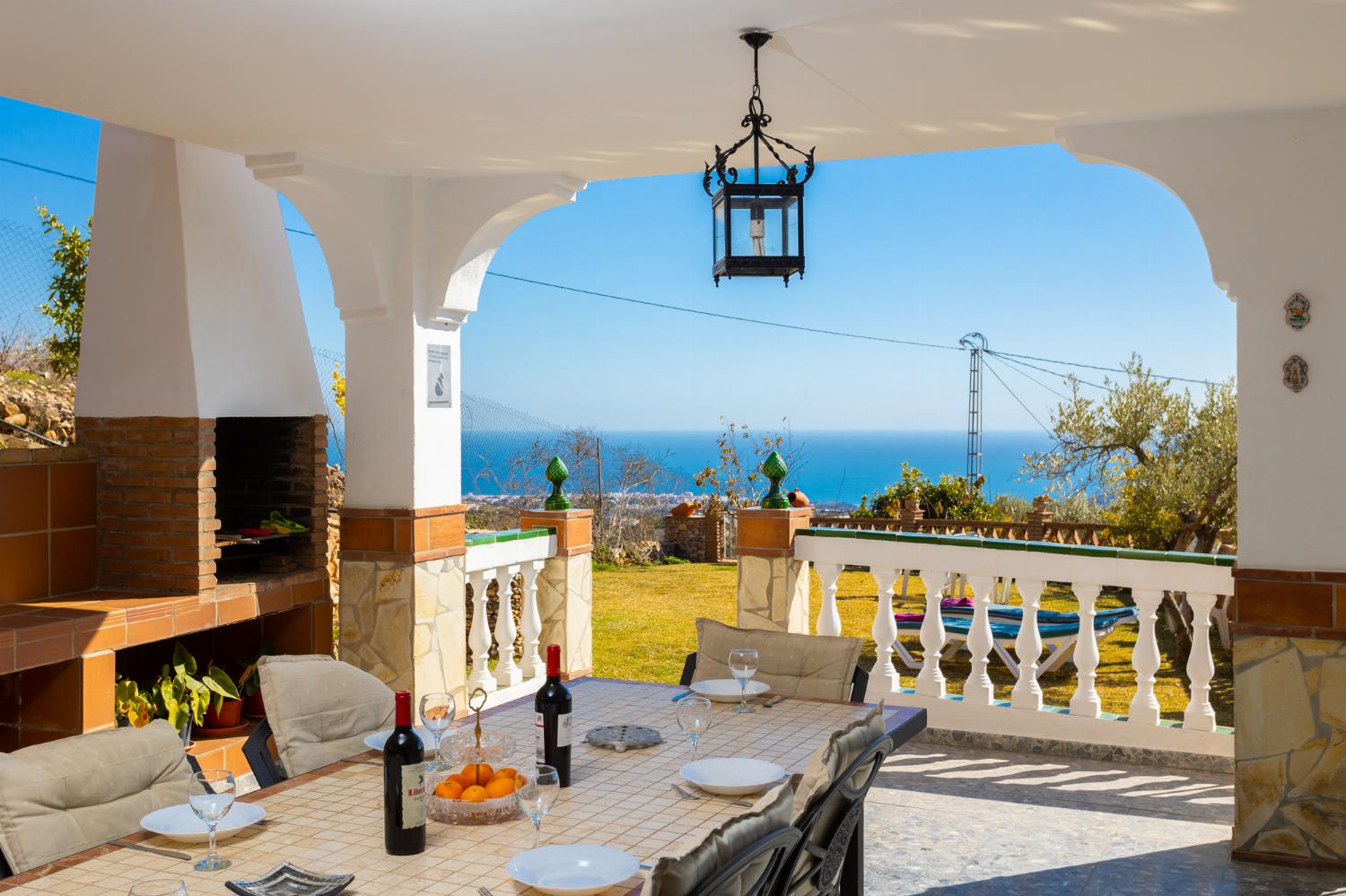 Sheltered terrace area with BBQ and sea views