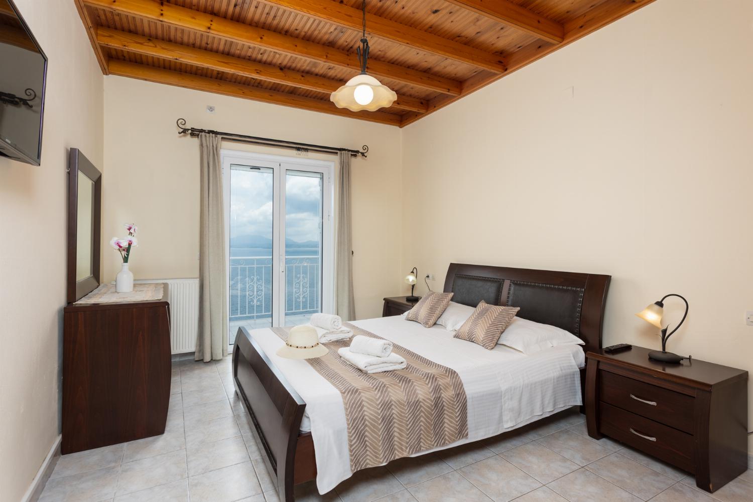 Double bedroom on first floor with TV, sea views, and balcony access
