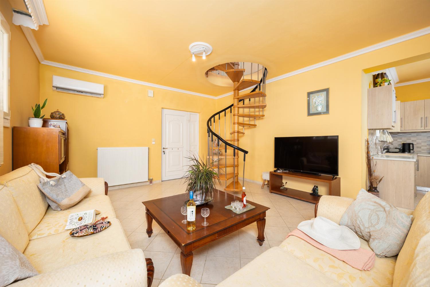 Ground floor: open-plan living room with sofas, dining area, kitchen, A/C, WiFi internet, satellite TV, and sea views