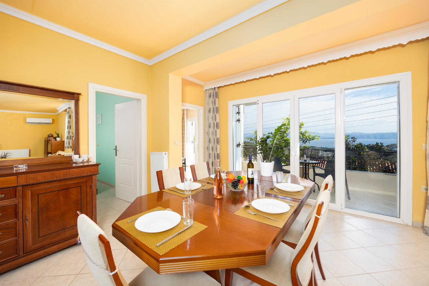 Ground floor: open-plan living room with sofas, dining area, kitchen, A/C, WiFi internet, satellite TV, and sea views