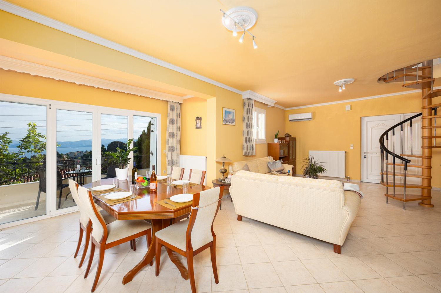 Ground floor: open-plan living room with sofas, dining area, kitchen, A/C, WiFi internet, satellite TV, and sea views