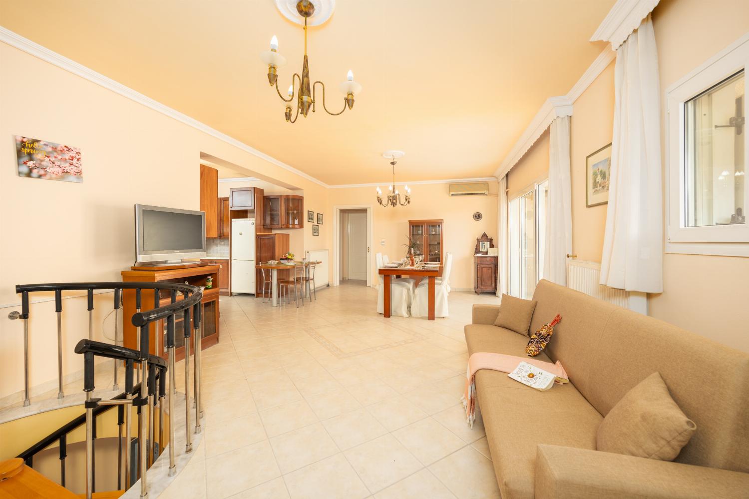 First floor: open-plan living room with sofa, dining area, kitchen, ornamental fireplace, A/C, WiFi internet, satellite TV, and sea views