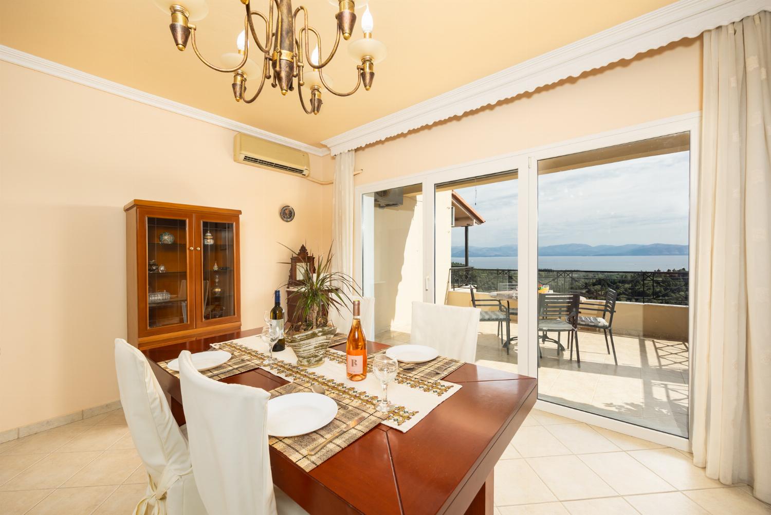 First floor: open-plan living room with sofa, dining area, kitchen, ornamental fireplace, A/C, WiFi internet, satellite TV, and sea views