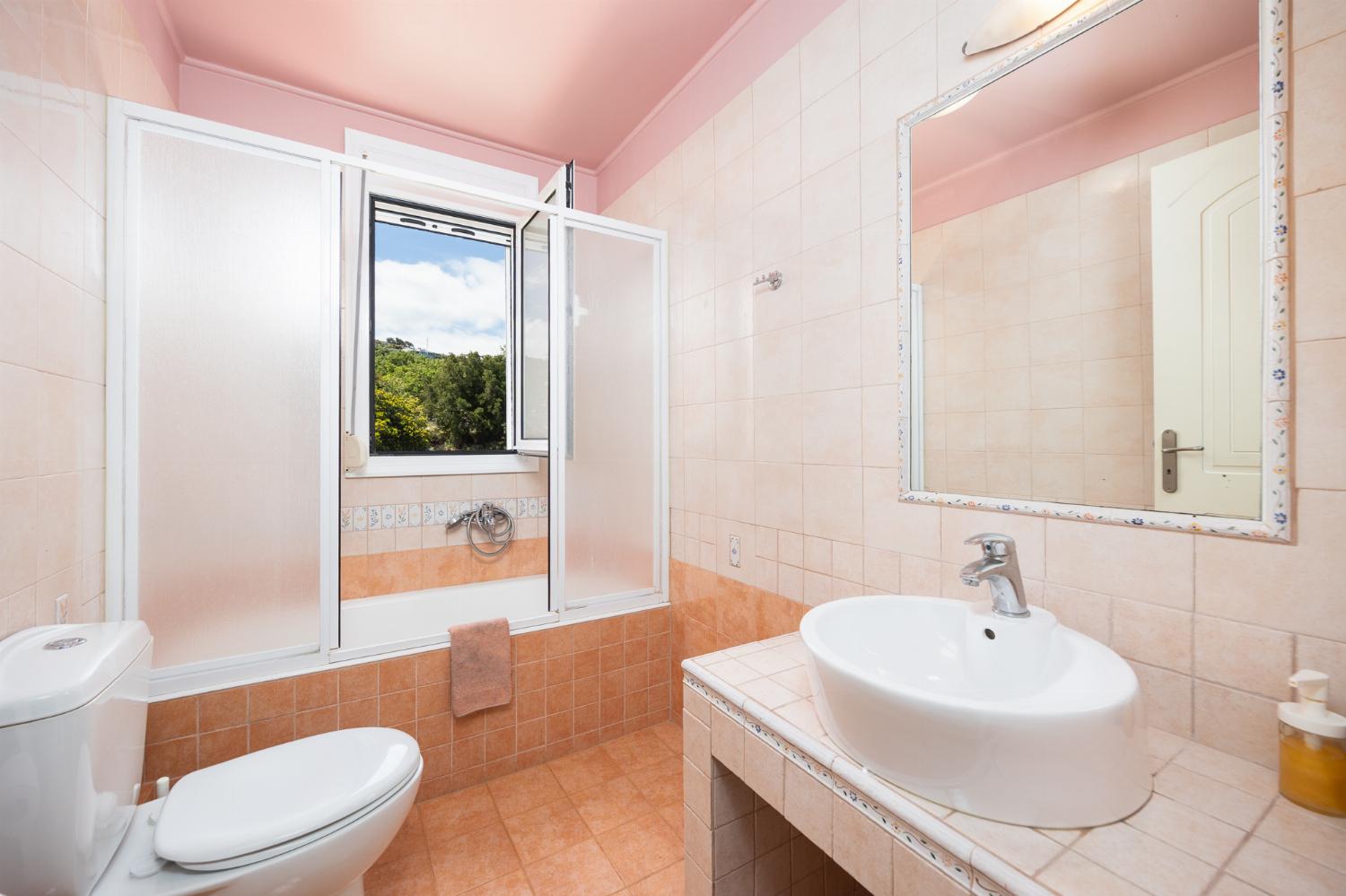 Family bathroom with bath and shower
