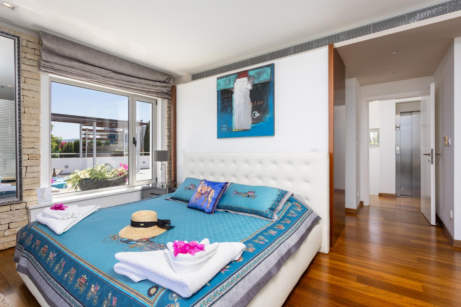 Double bedroom on second floor with en suite bathroom, A/C, sea views, and balcony access