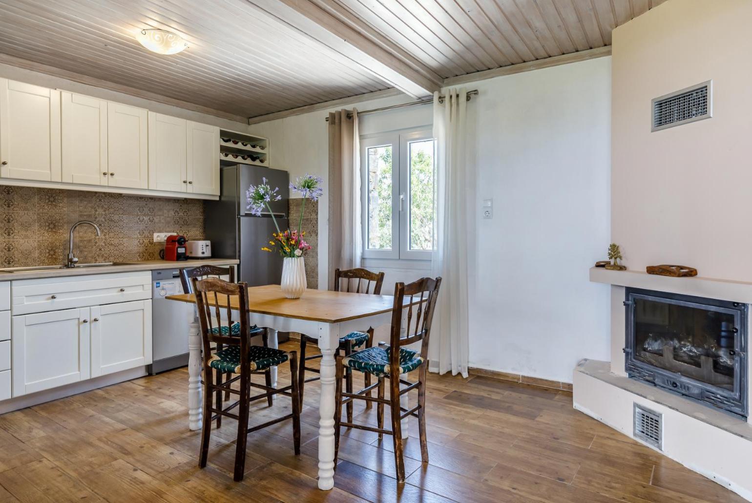 Fully equipped kitchen, and indoor dining area with a fireplace