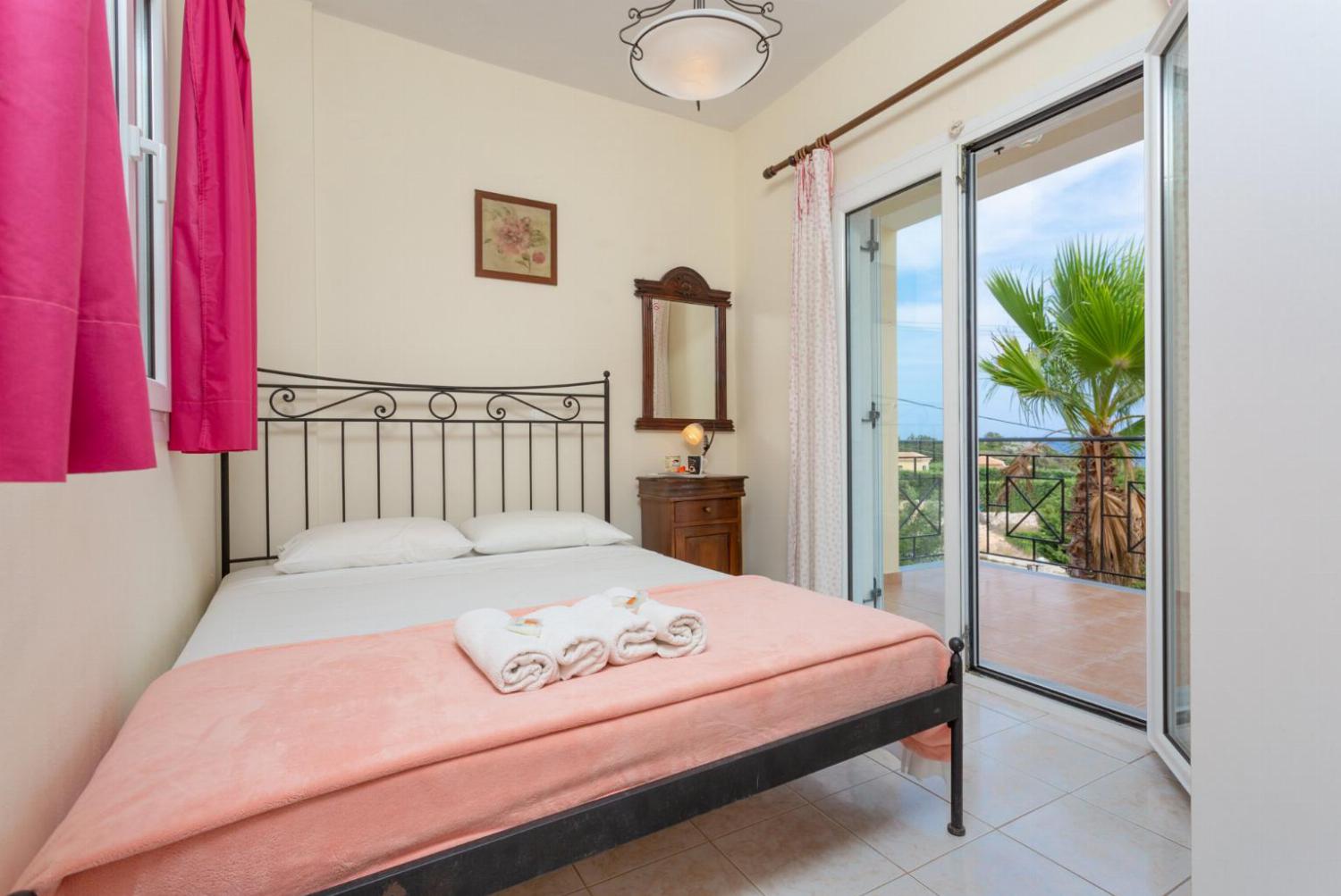 Double bedroom on first floor with A/C, and balcony access with sea views